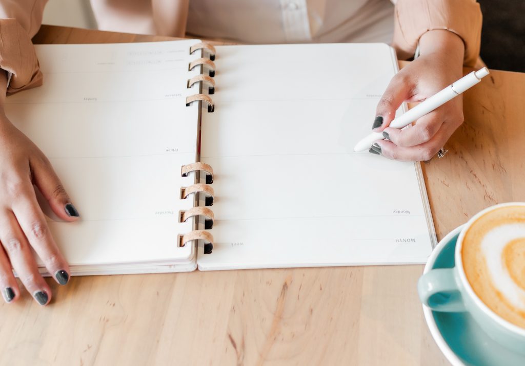 Female entrepreneur writing in notebook